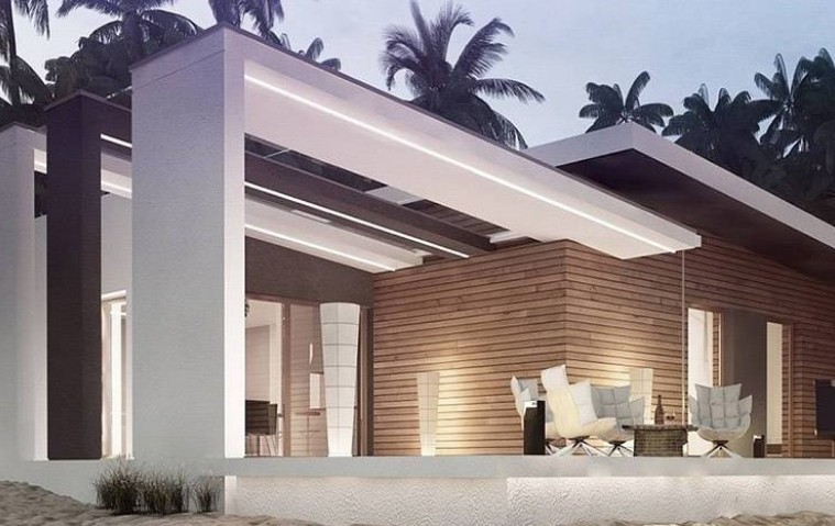 Casa moderna de playa construida por Modulares S&R Fábrica, con diseño minimalista, acabados en madera y concreto, rodeada de palmeras tropicales.